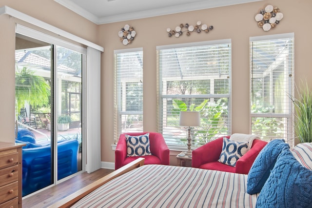 6341 Augusta Cv, Destin, FL 32541 - bedroom with crown molding, wood finished floors, and access to exterior