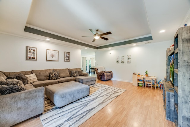 5981 Creekside Cir, Crestview, FL 32536 - living room featuring a raised ceiling, ceiling fan, crown molding, light wood-type flooring, and recessed lighting