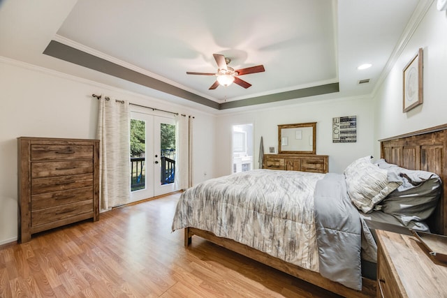 5981 Creekside Cir, Crestview, FL 32536 - bedroom featuring a raised ceiling, french doors, access to exterior, light wood-style flooring, and crown molding