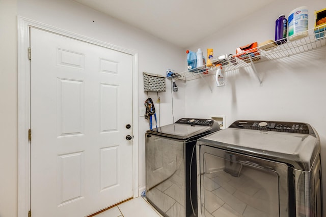5981 Creekside Cir, Crestview, FL 32536 - laundry area with washing machine and clothes dryer and light tile patterned floors