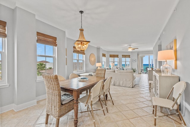 164 Blue Lupine Way Unit 411, Santa Rosa Beach, FL 32459 - dining space with a chandelier, stone tile flooring, and a ceiling fan