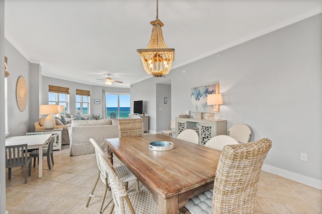 164 Blue Lupine Way Unit 411, Santa Rosa Beach, FL 32459 - dining space featuring a chandelier, a ceiling fan, light tile patterned floors, and ornamental molding