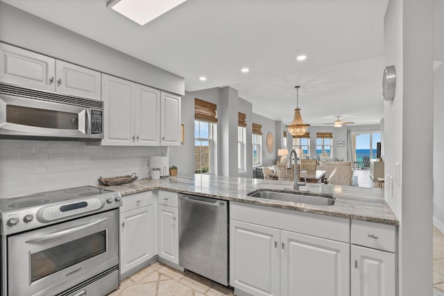 164 Blue Lupine Way Unit 411, Santa Rosa Beach, FL 32459 - kitchen featuring appliances with stainless steel finishes, decorative backsplash, white cabinets, healthy amount of natural light, and recessed lighting