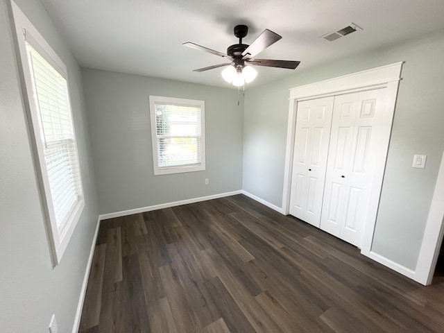 612 NE Powell Dr, Fort Walton Beach, FL 32547 - unfurnished bedroom featuring dark wood-style flooring, ceiling fan, and a closet