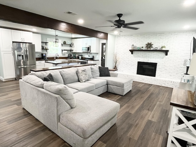 612 NE Powell Dr, Fort Walton Beach, FL 32547 - living area with ceiling fan, dark wood-style floors, a brick fireplace, and brick wall