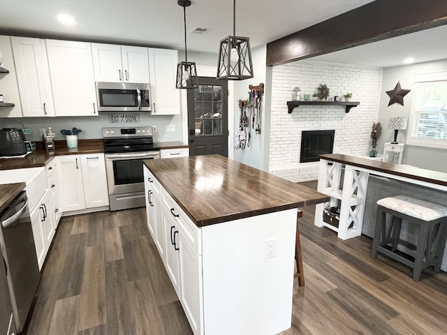 612 NE Powell Dr, Fort Walton Beach, FL 32547 - kitchen with stainless steel appliances, wooden counters, dark wood-style flooring, white cabinetry, and recessed lighting