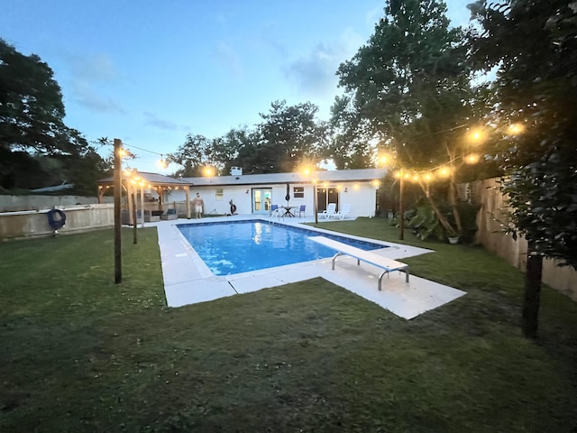 612 NE Powell Dr, Fort Walton Beach, FL 32547 - view of swimming pool featuring a patio, a fenced backyard, and a diving board