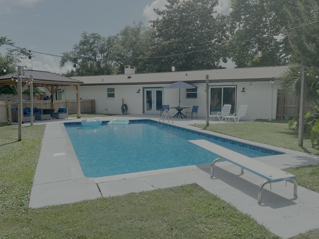 612 NE Powell Dr, Fort Walton Beach, FL 32547 - swimming pool with outdoor lounge area, french doors, a gazebo, a patio area, and a diving board