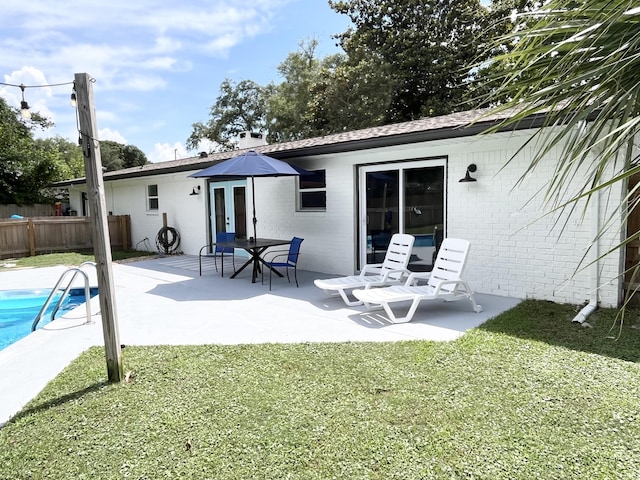 612 NE Powell Dr, Fort Walton Beach, FL 32547 - rear view of property featuring brick siding, a patio, and french doors