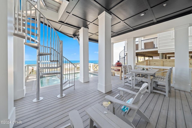 19989 Front Beach Rd, Panama City Beach, FL 32413 - wooden terrace with stairway, a water view, and outdoor dining space