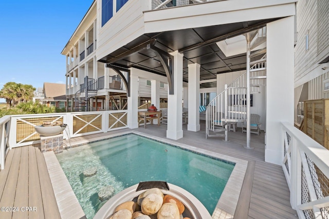 19989 Front Beach Rd, Panama City Beach, FL 32413 - outdoor pool featuring stairway, a wooden deck, and a fire pit