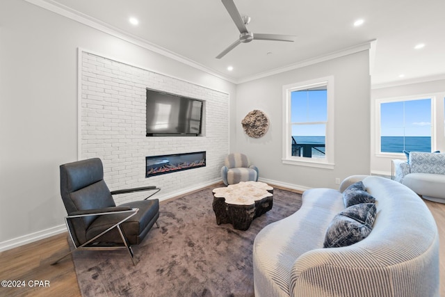 19989 Front Beach Rd, Panama City Beach, FL 32413 - living room with wood finished floors, a glass covered fireplace, a ceiling fan, recessed lighting, and ornamental molding