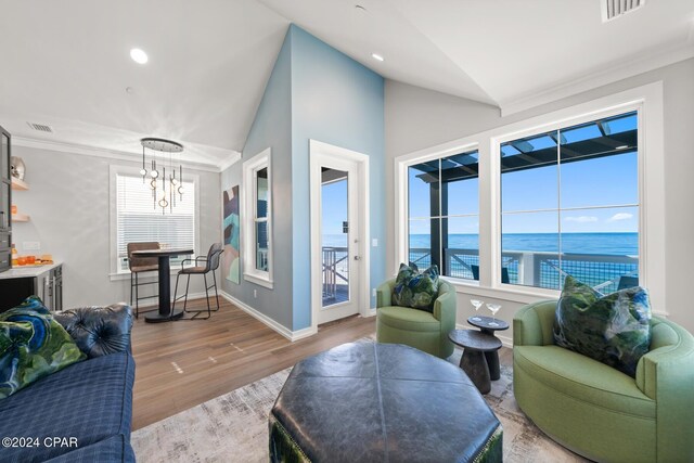 19989 Front Beach Rd, Panama City Beach, FL 32413 - living room featuring lofted ceiling, a chandelier, wood finished floors, recessed lighting, and a water view
