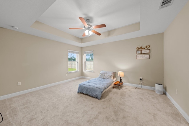8152 Nevada St, Navarre, FL 32566 - carpeted bedroom featuring a tray ceiling and a ceiling fan