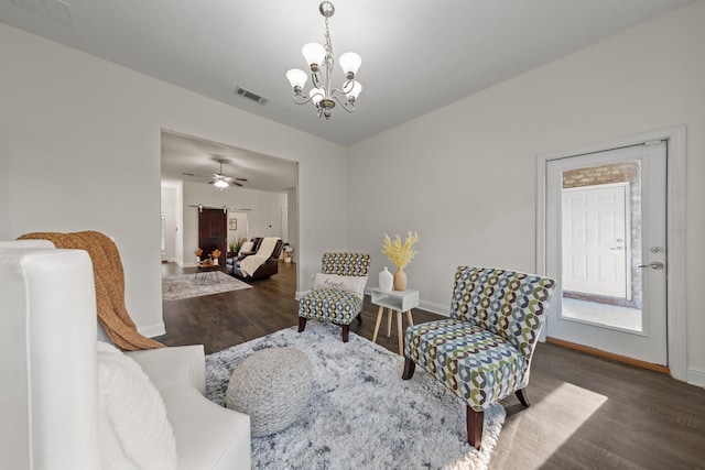 8152 Nevada St, Navarre, FL 32566 - living room with wood finished floors, a chandelier, and a ceiling fan