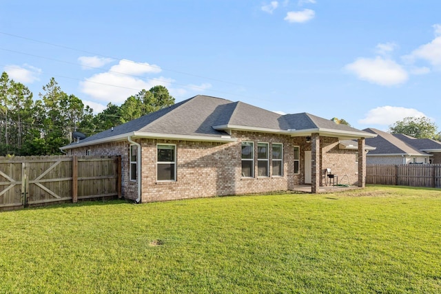 8152 Nevada St, Navarre, FL 32566 - back of property featuring brick siding, a fenced backyard, and roof with shingles