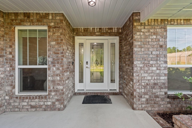 8152 Nevada St, Navarre, FL 32566 - doorway to property with brick siding and a porch