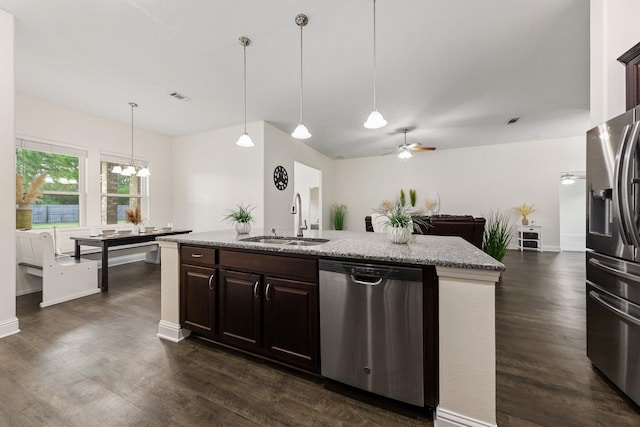 8152 Nevada St, Navarre, FL 32566 - kitchen featuring stainless steel appliances, dark wood finished floors, a center island with sink, and dark brown cabinetry