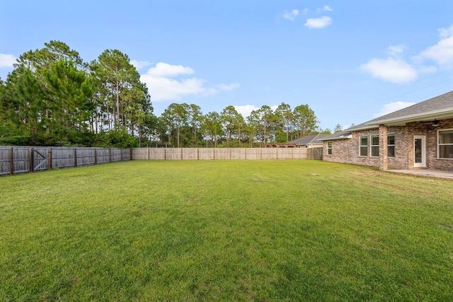 8152 Nevada St, Navarre, FL 32566 - fenced backyard featuring ceiling fan and a patio area