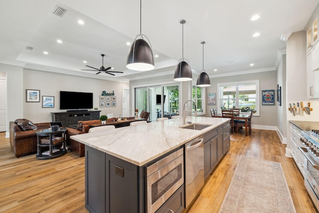 508 W Point Washington Rd, Santa Rosa Beach, FL 32459 - kitchen featuring stainless steel appliances, light wood-style flooring, recessed lighting, an island with sink, and ornamental molding