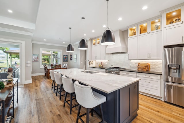 508 W Point Washington Rd, Santa Rosa Beach, FL 32459 - kitchen with appliances with stainless steel finishes, premium range hood, decorative backsplash, an island with sink, and crown molding
