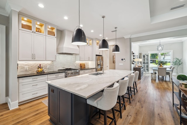 508 W Point Washington Rd, Santa Rosa Beach, FL 32459 - kitchen with premium range hood, crown molding, decorative backsplash, a large island, and white cabinetry