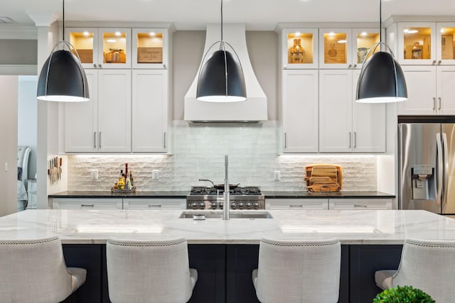 508 W Point Washington Rd, Santa Rosa Beach, FL 32459 - kitchen with stainless steel fridge, wall chimney exhaust hood, tasteful backsplash, and white cabinetry