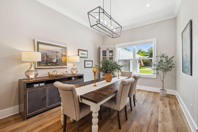 508 W Point Washington Rd, Santa Rosa Beach, FL 32459 - dining space featuring crown molding, a chandelier, wood finished floors, and recessed lighting