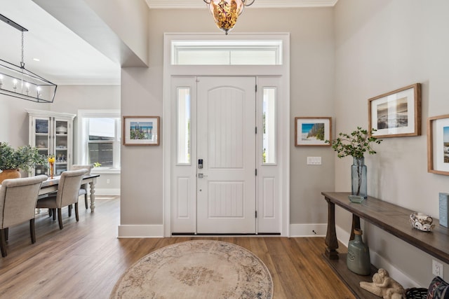 508 W Point Washington Rd, Santa Rosa Beach, FL 32459 - entryway with a chandelier, wood finished floors, ornamental molding, and healthy amount of natural light