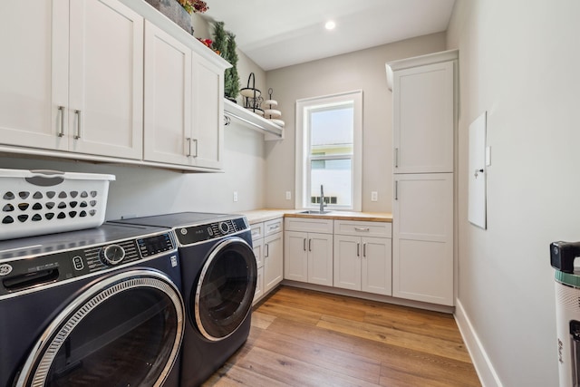 508 W Point Washington Rd, Santa Rosa Beach, FL 32459 - washroom with independent washer and dryer, cabinet space, light wood finished floors, and recessed lighting
