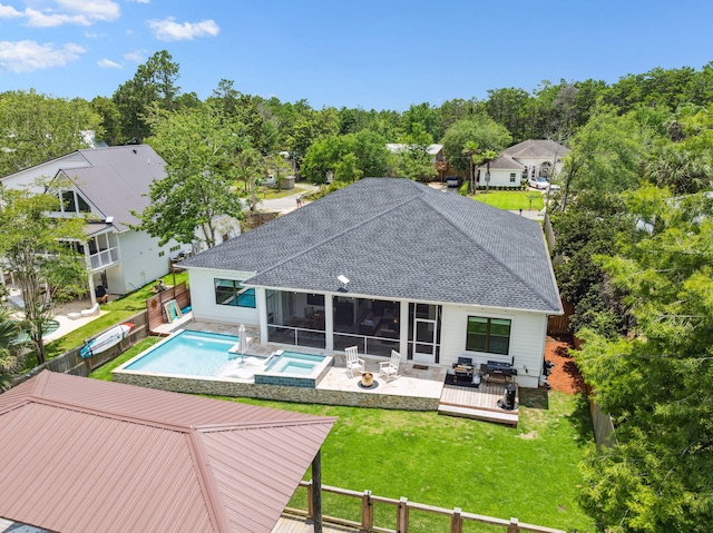 508 W Point Washington Rd, Santa Rosa Beach, FL 32459 - rear view of house featuring roof with shingles, an in-ground hot tub, an outdoor pool, a sunroom, and a fenced backyard