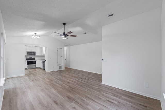 1816 Madelons Path, Fort Walton Beach, FL 32547 - unfurnished living room with a ceiling fan, light wood finished floors, vaulted ceiling, a chandelier, and a textured ceiling
