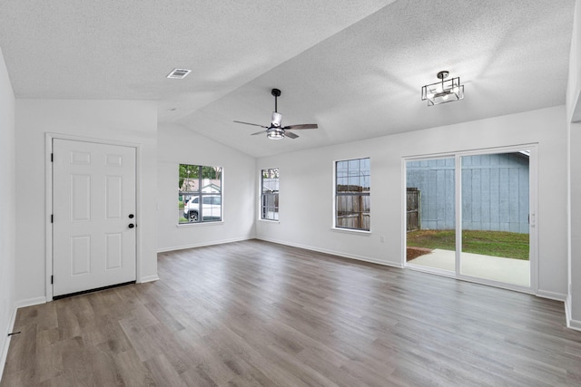 1816 Madelons Path, Fort Walton Beach, FL 32547 - unfurnished living room featuring a textured ceiling, wood finished floors, lofted ceiling, and a ceiling fan
