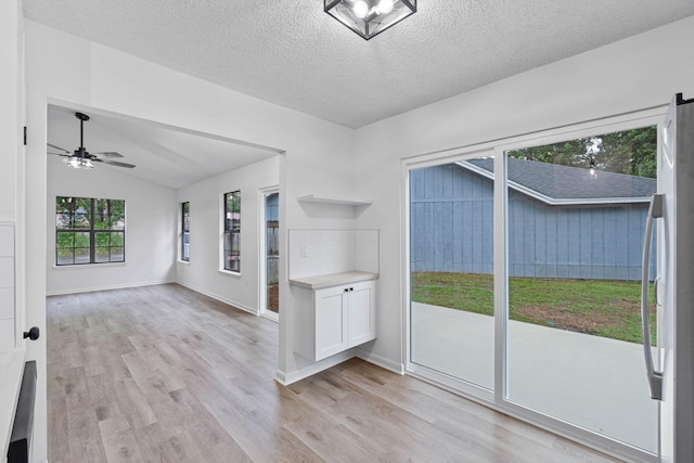 1816 Madelons Path, Fort Walton Beach, FL 32547 - empty room with light wood finished floors, a ceiling fan, a textured ceiling, and vaulted ceiling