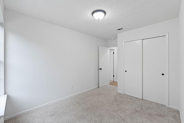 1816 Madelons Path, Fort Walton Beach, FL 32547 - unfurnished bedroom with carpet flooring, a textured ceiling, and a closet
