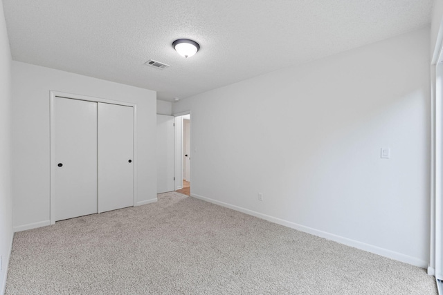 1816 Madelons Path, Fort Walton Beach, FL 32547 - unfurnished bedroom featuring a textured ceiling, a closet, and carpet floors
