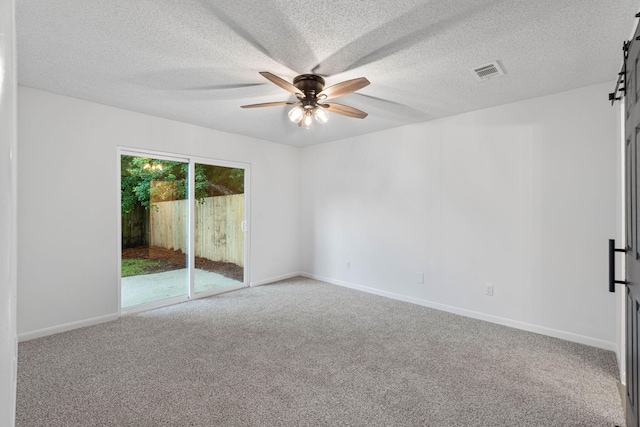 1816 Madelons Path, Fort Walton Beach, FL 32547 - empty room featuring a ceiling fan, a barn door, carpet, and a textured ceiling