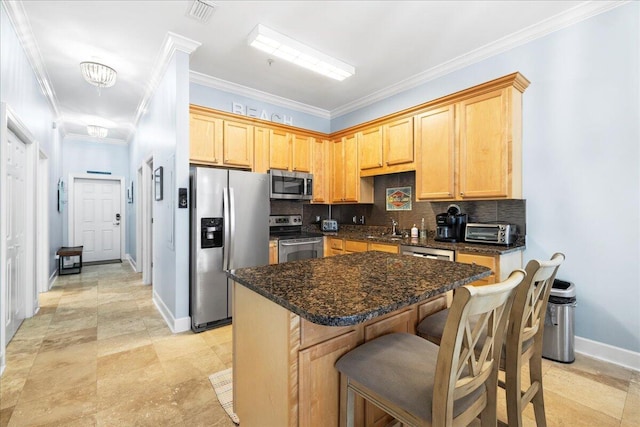 231 Somerset Bridge Rd Unit 1209, Santa Rosa Beach, FL 32459 - kitchen with stainless steel appliances, tasteful backsplash, ornamental molding, a kitchen island, and a kitchen breakfast bar