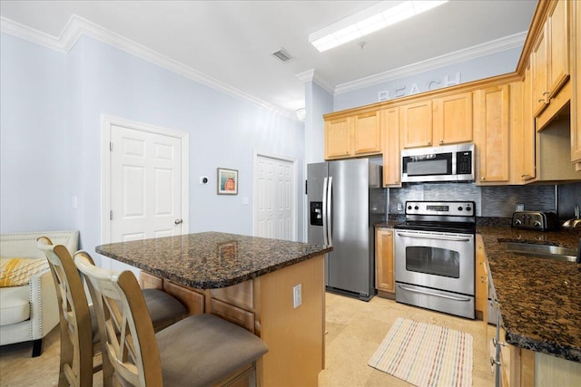 231 Somerset Bridge Rd Unit 1209, Santa Rosa Beach, FL 32459 - kitchen with stainless steel appliances, backsplash, crown molding, a kitchen breakfast bar, and a kitchen island