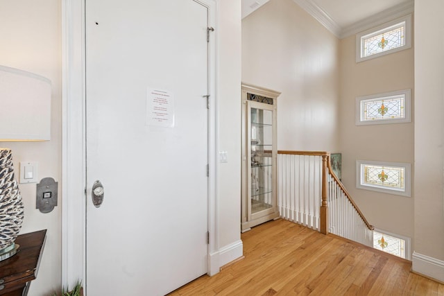 19108 Front Beach Rd Unit A & B, Panama City Beach, FL 32413 - corridor with an upstairs landing, light wood-type flooring, a high ceiling, and crown molding