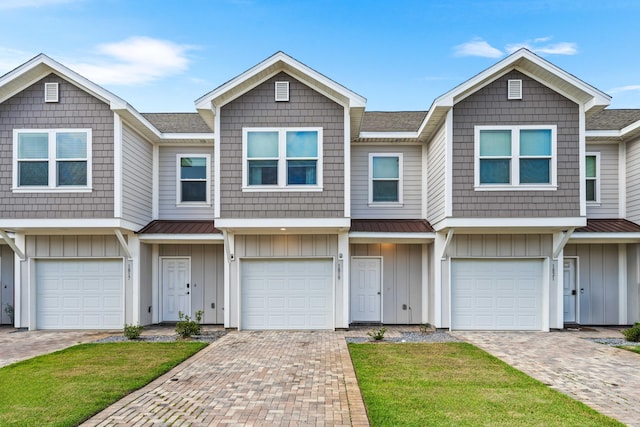 1819 Stable Ln, Fort Walton Beach, FL 32547 - multi unit property featuring board and batten siding, a shingled roof, decorative driveway, and a garage