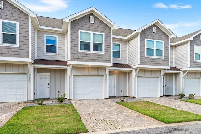 1819 Stable Ln, Fort Walton Beach, FL 32547 - townhome / multi-family property with board and batten siding, a metal roof, roof with shingles, and driveway