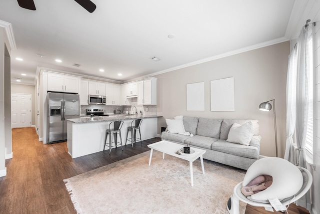 1819 Stable Ln, Fort Walton Beach, FL 32547 - living area with wood finished floors, ceiling fan, crown molding, and recessed lighting