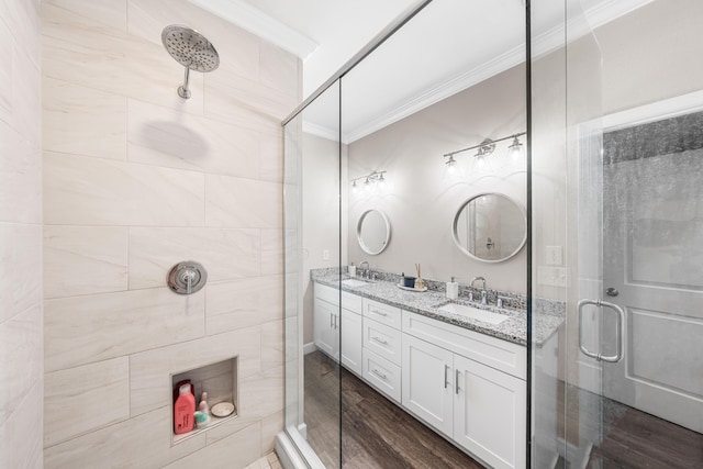 1819 Stable Ln, Fort Walton Beach, FL 32547 - full bathroom featuring crown molding, a stall shower, double vanity, and wood finished floors
