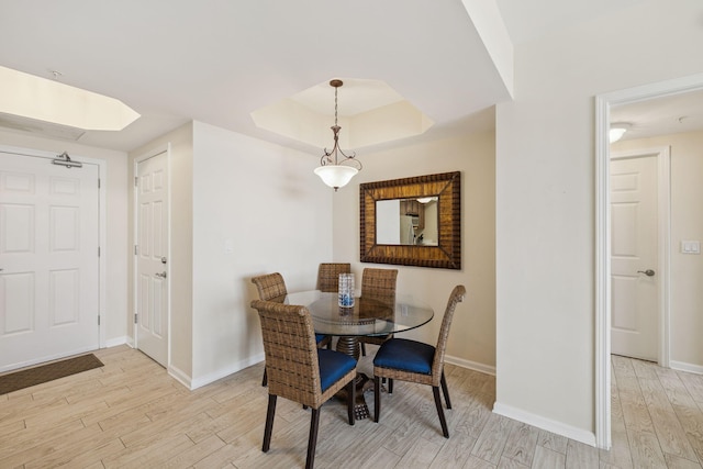 15100 Emerald Coast Pkwy Unit 602, Destin, FL 32541 - dining area with light wood-style floors and a tray ceiling