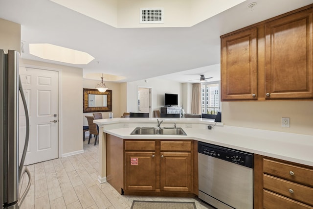 15100 Emerald Coast Pkwy Unit 602, Destin, FL 32541 - kitchen with stainless steel dishwasher, fridge, a peninsula, and brown cabinets