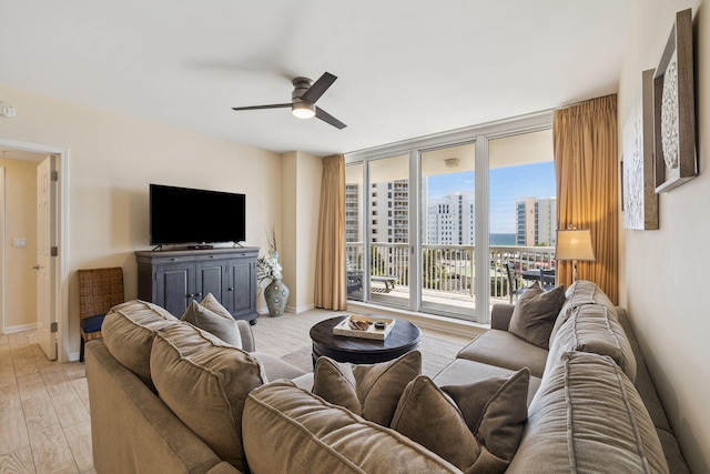 15100 Emerald Coast Pkwy Unit 602, Destin, FL 32541 - living area featuring ceiling fan, expansive windows, and light wood-style floors