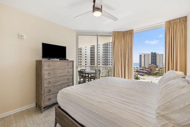 15100 Emerald Coast Pkwy Unit 602, Destin, FL 32541 - bedroom with wood finished floors, floor to ceiling windows, access to outside, and ceiling fan