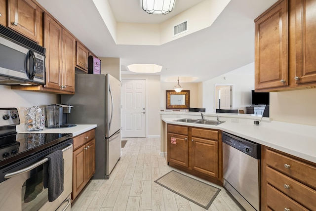 15100 Emerald Coast Pkwy Unit 602, Destin, FL 32541 - kitchen with stainless steel appliances, brown cabinetry, light wood finished floors, and light countertops