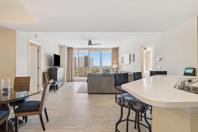 15100 Emerald Coast Pkwy Unit 602, Destin, FL 32541 - dining room with light wood finished floors, a wall of windows, and a ceiling fan